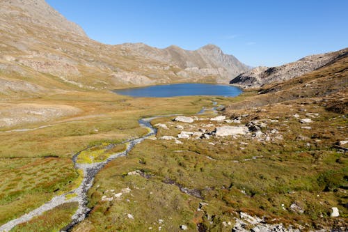 Stream and Lake in Valley in Mountains