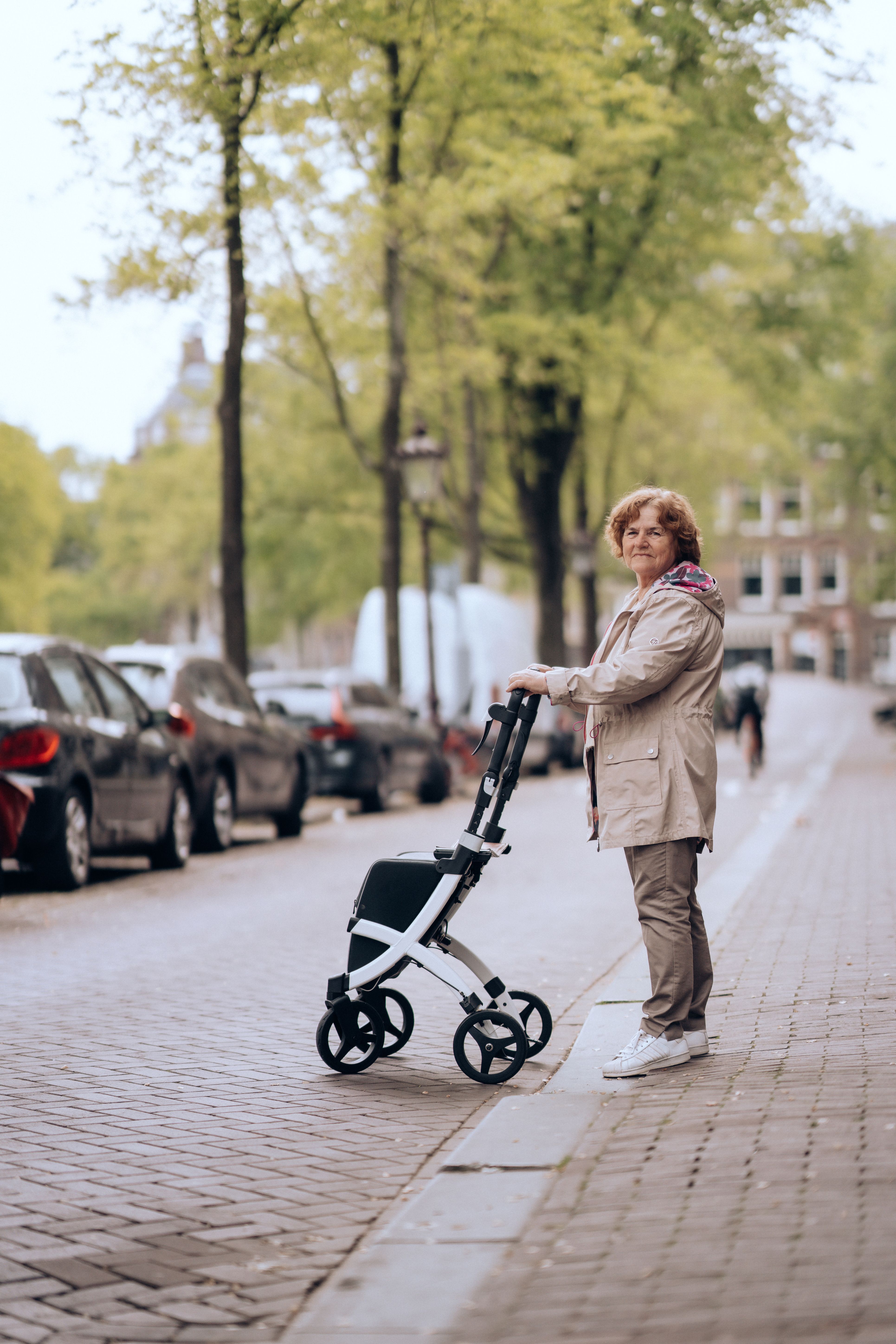 Elderly Woman with Wheeled Walker Crossing the Street · Free Stock Photo