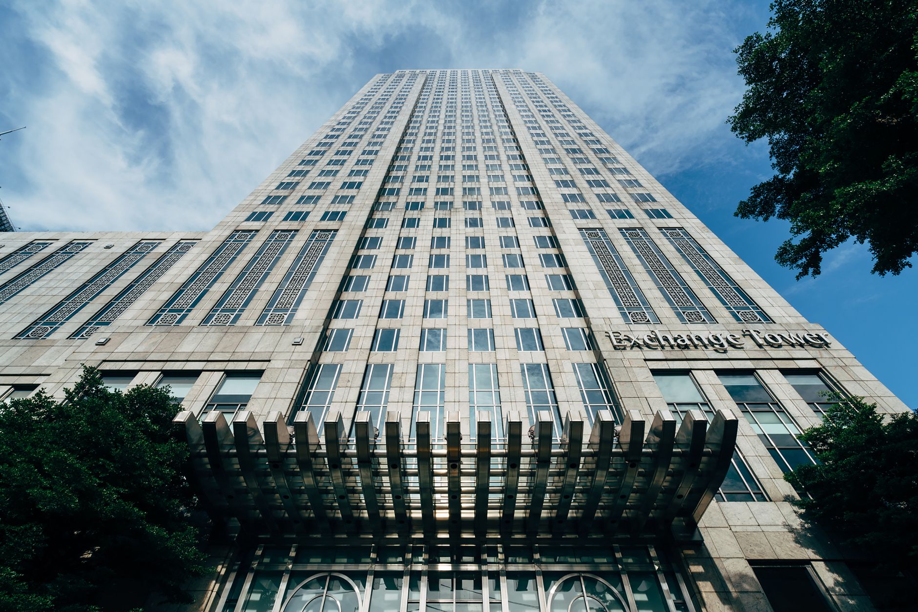 Stunning low angle shot of Exchange Tower in Bangkok, Thailand, highlighting its architectural elegance.