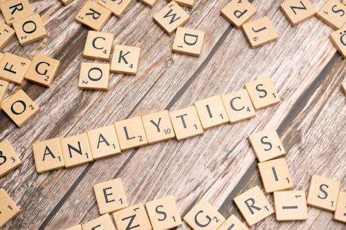The word analytics spelled out in scrabble tiles