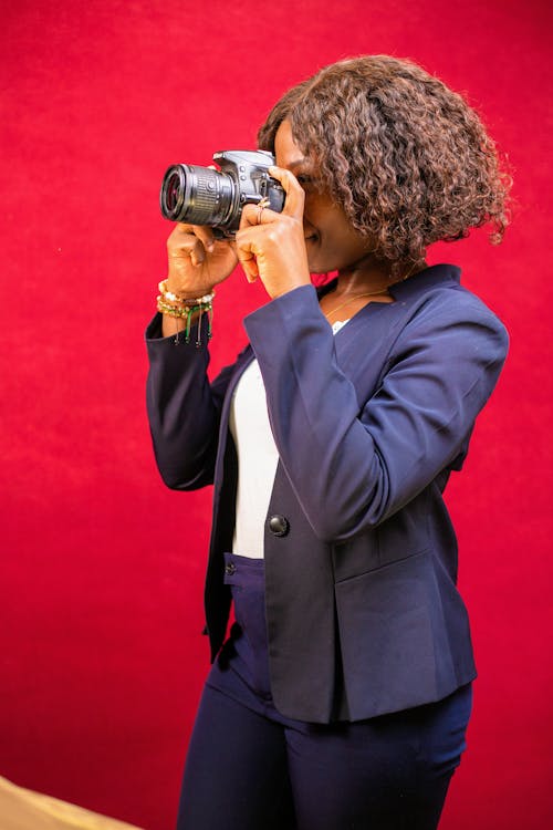Woman in Suit Taking Pictures with Camera