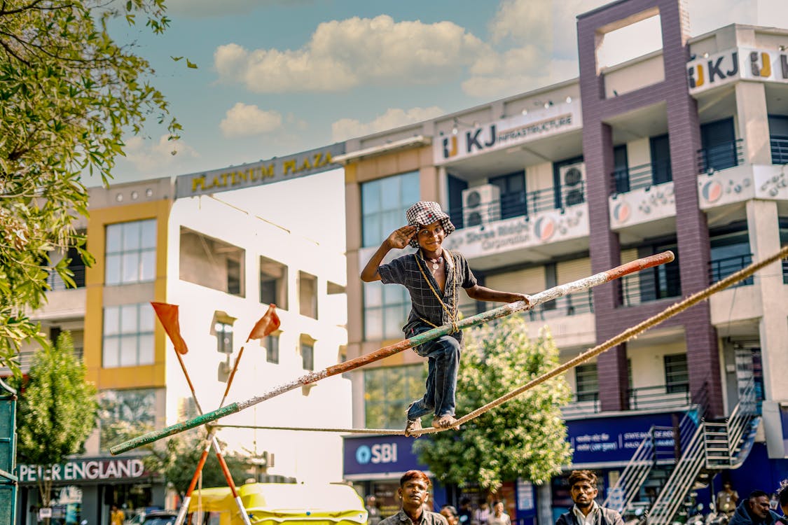 Smiling Boy Balancing on Rope ยท Free Stock Photo