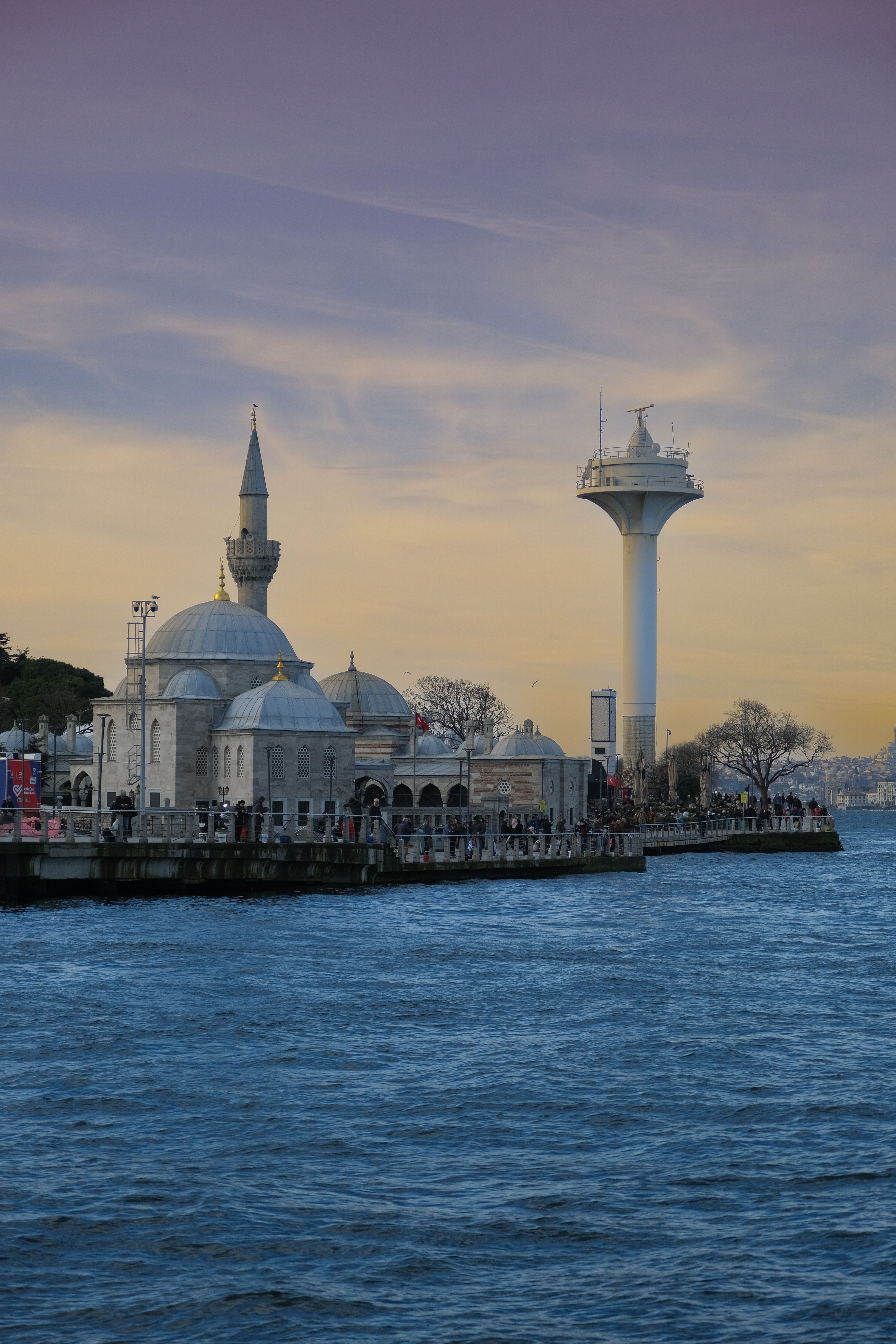 Scenic sunset over Istanbul with the Şemsi Ahmet Pasha Mosque by the Bosphorus coast.