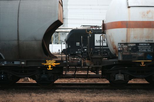 Detailed shot of cargo train cars on a railway in Hungary, illustrating logistics and transportation themes.