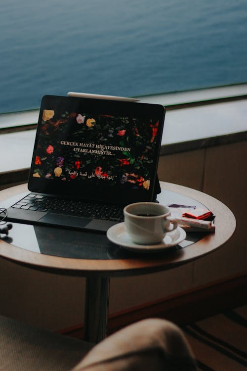 Free A Tablet with a Keyboard and a Cup of Coffee Standing on a Table Stock Photo