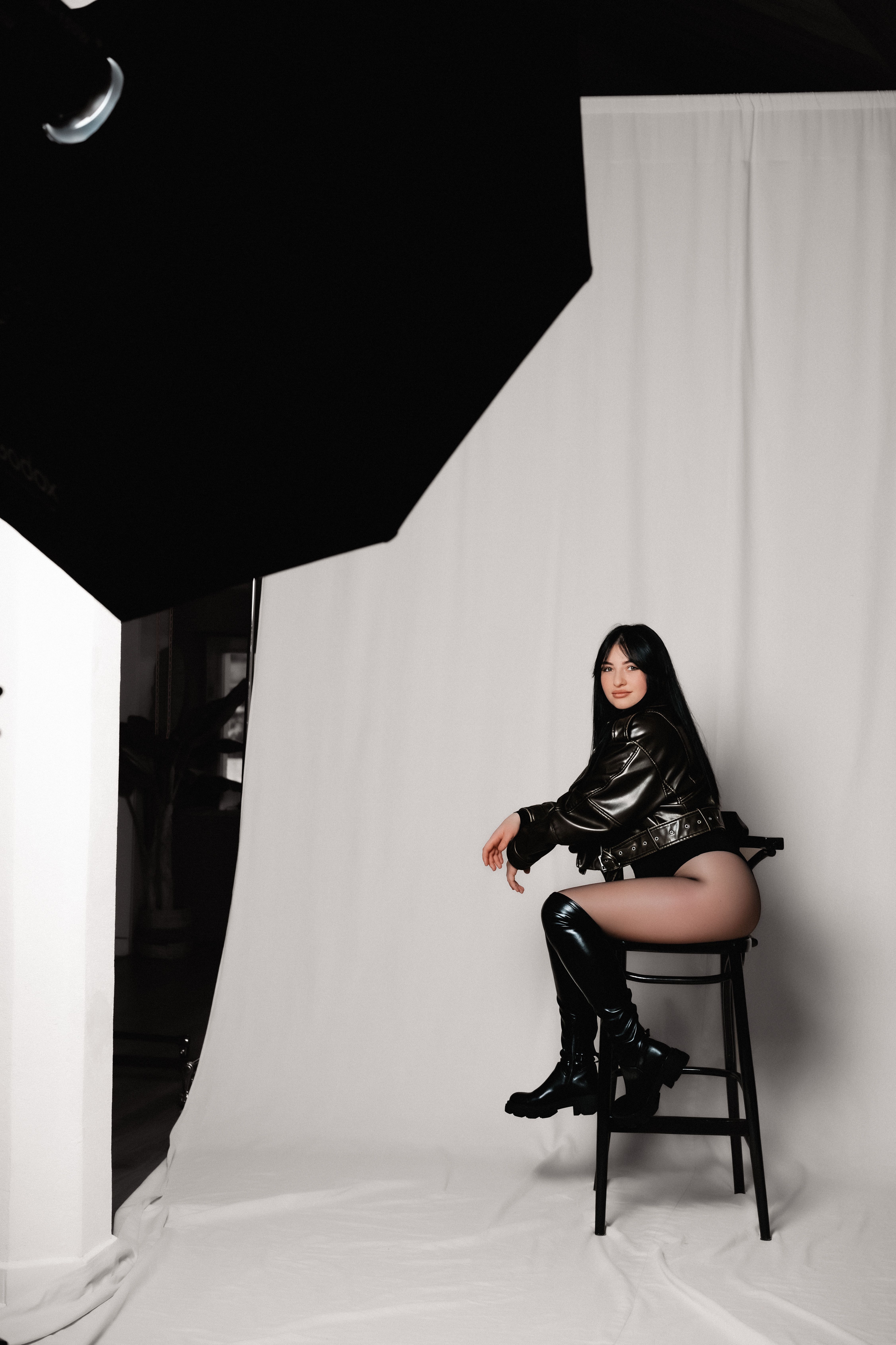 Woman in Leather Jacket Sitting on Chair at Studio · Free Stock Photo