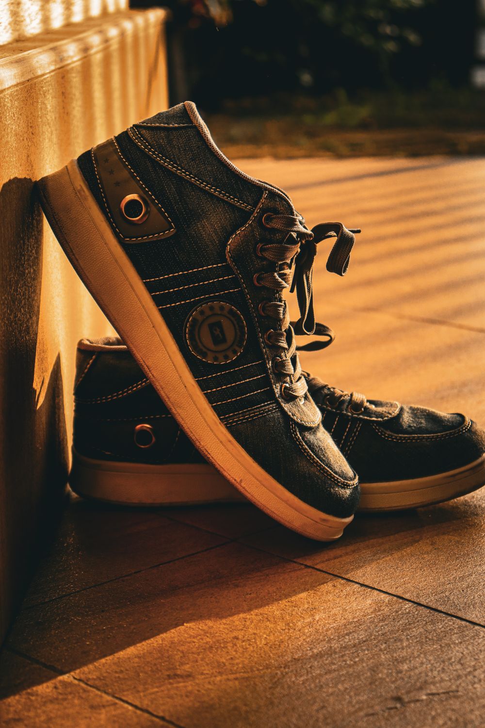 Sneaker styled against a sunlit wall