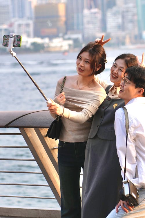 Smiling Women and Man Taking Selfie