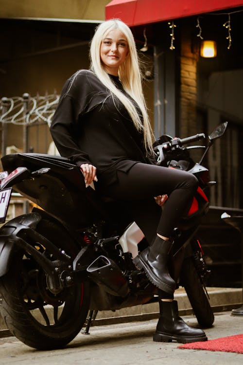 Smiling Woman Sitting on Motorbike