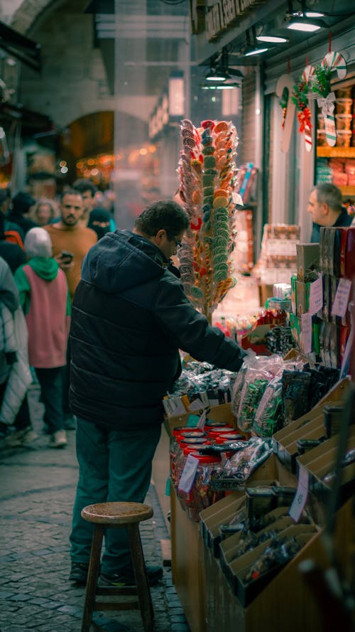 Man Buying Sweets on Market at Night