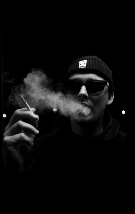 Man in Beanie Hat Smoking Cigarette · Free Stock Photo