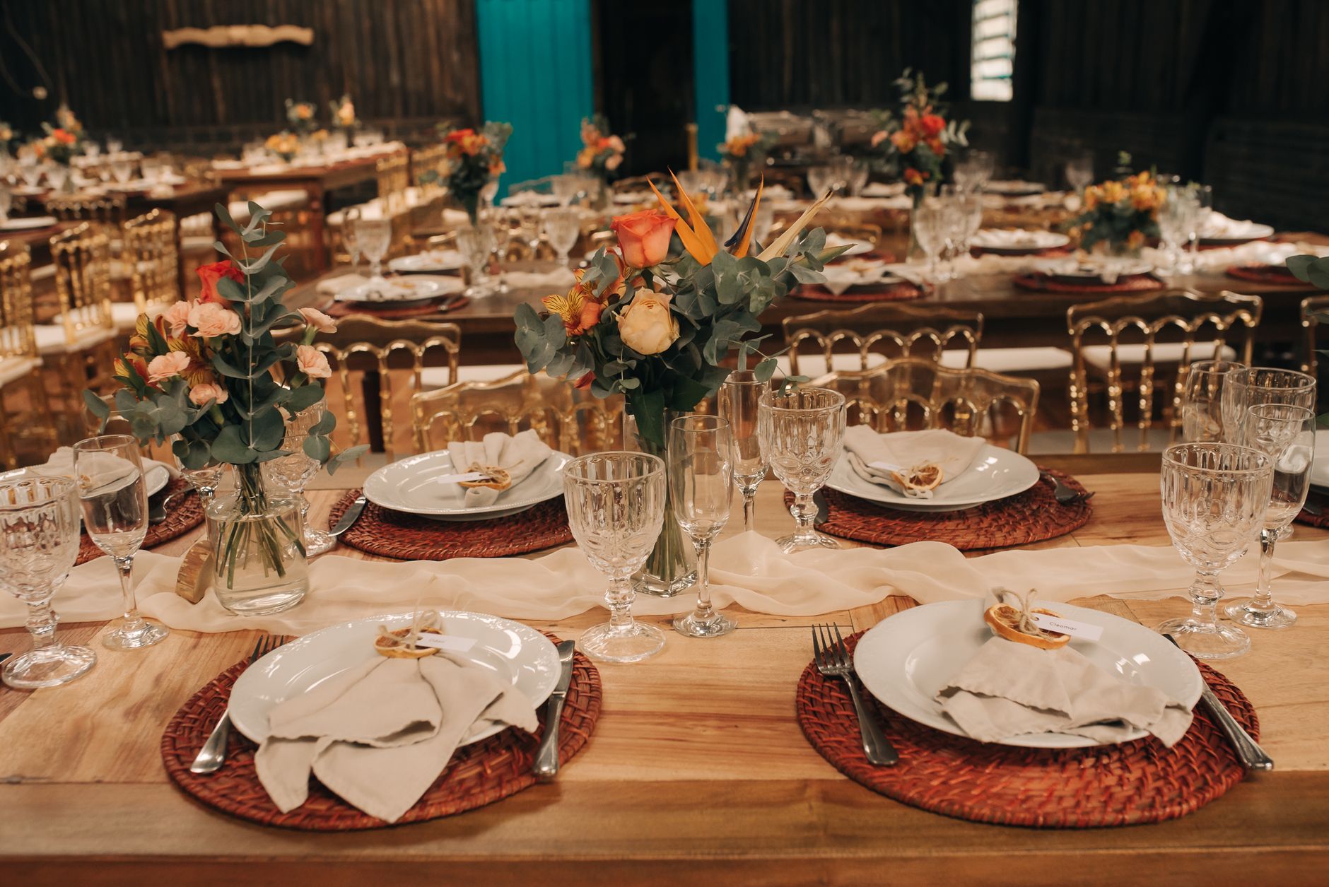 A beautifully arranged wedding reception table with flowers and elegant dinnerware.