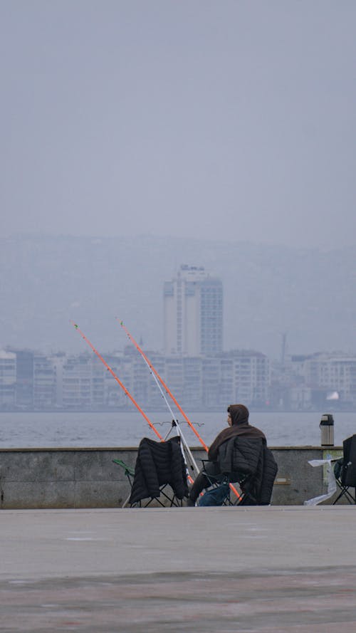 Angler Sitting on Promenade