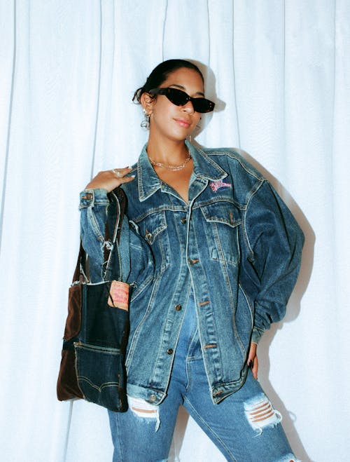 Woman in Jean Jacket Standing with Bag