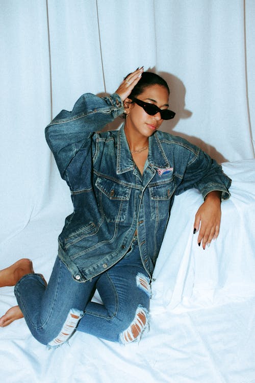 Brunette Woman Kneeling in Jeans and Jean Jacket