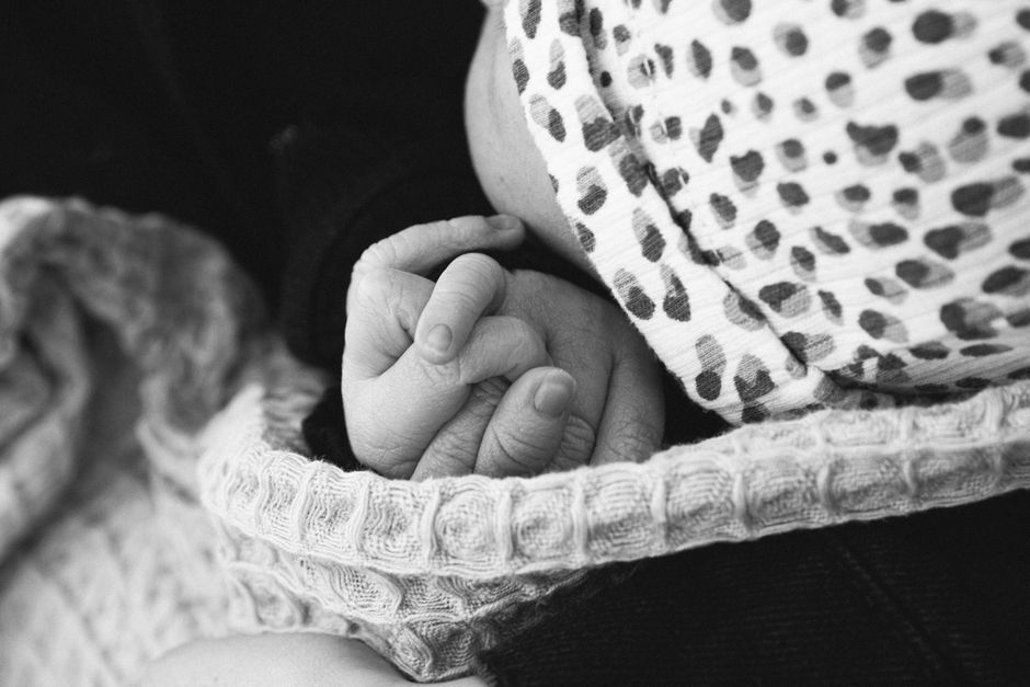 hands holding baby closeup