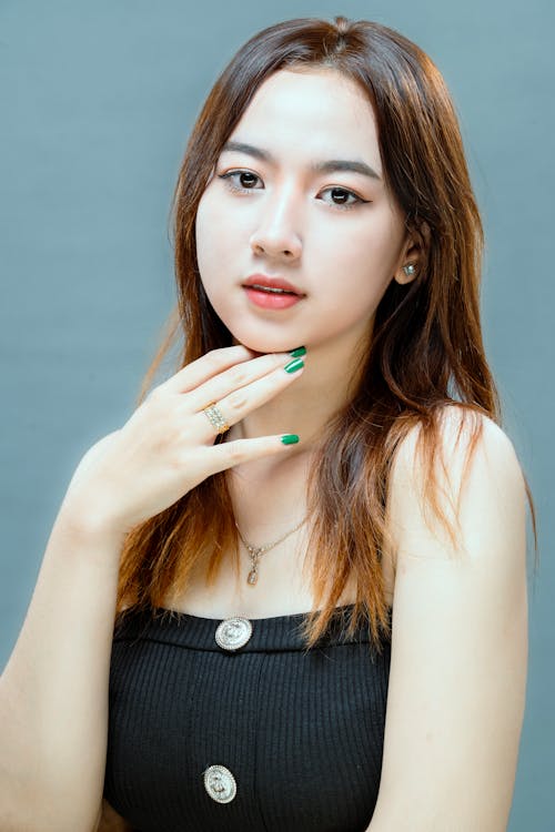 A woman with green nails and a black top