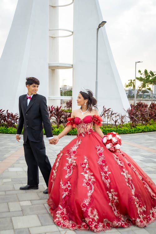 Man in Black Suit and Woman in Red Dress