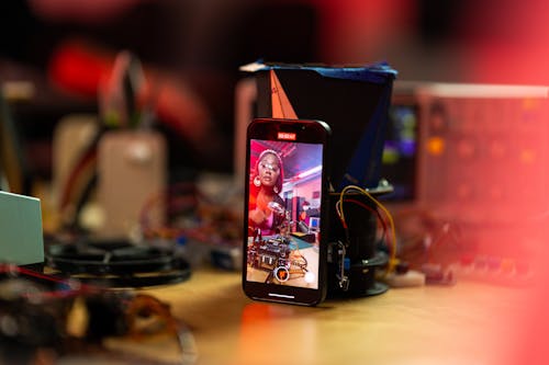 Woman Recording Herself with Smartphone on Desk