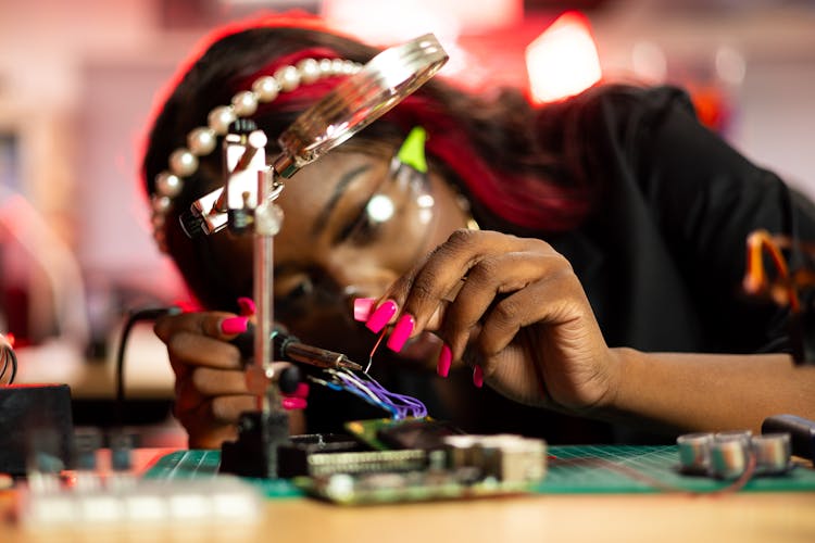 Woman Working On Computer Hardware