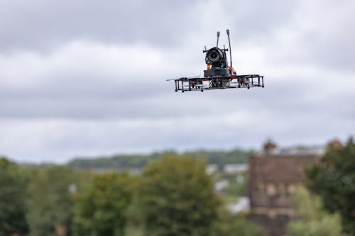 Plastic Drone with Camera Flying in Air