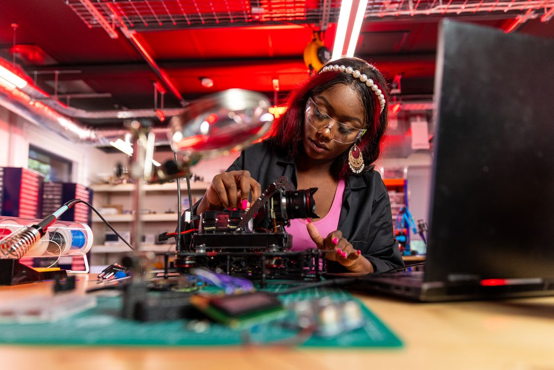 Fixing Digital Woman in a Repair Shop Fixing a Digital Camera · Free Stock Photo