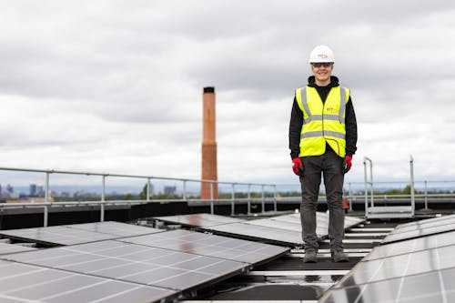 Engineer Standing among Solar Panels