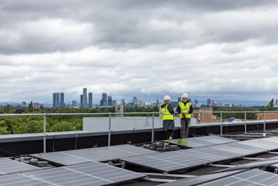 Workers installing roof solar panels in a city.  Credit thisisengineering via Pexels