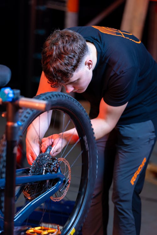Teenage Boy Fixing a Bicycle 