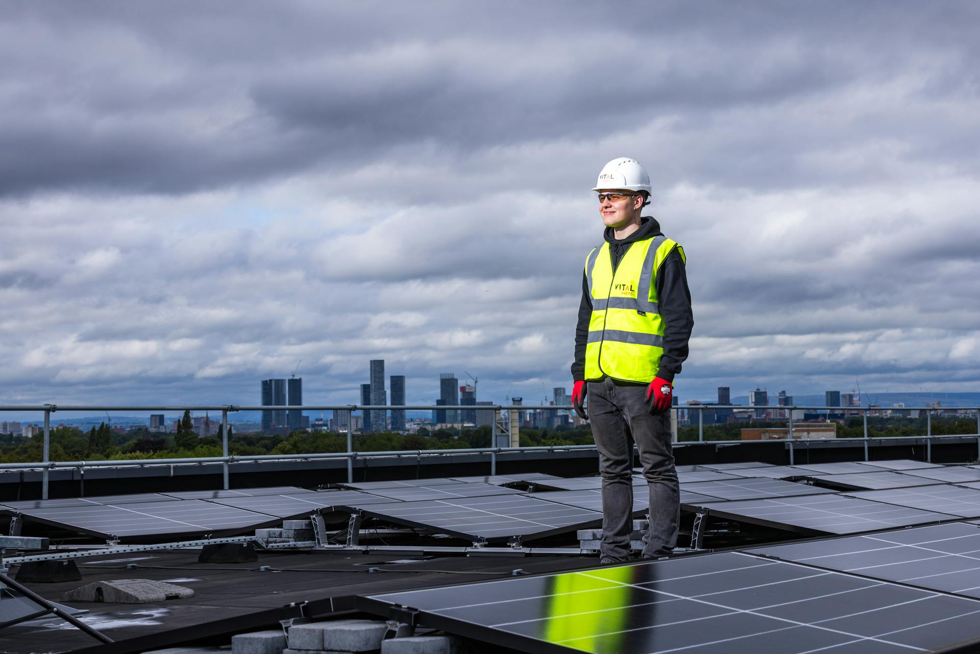 Man Standing among Solar Panels