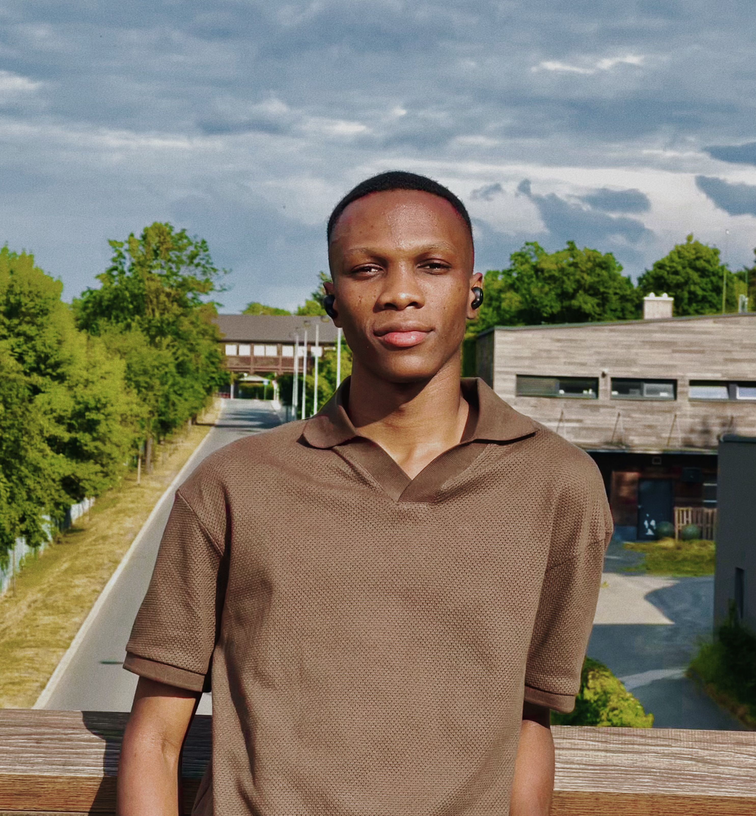 Portrait of a Young Man Standing on a Bridge · Free Stock Photo