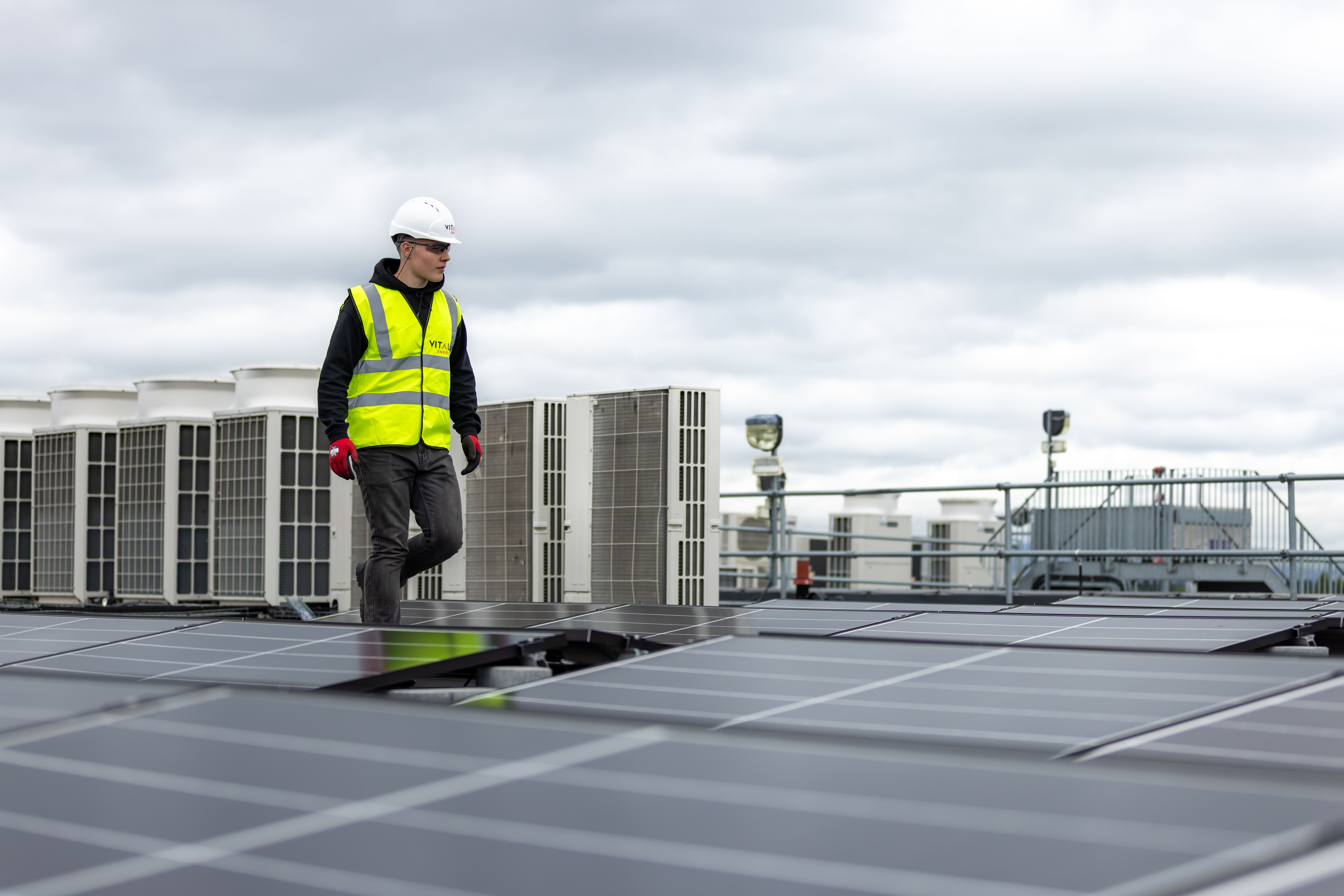 Engineer inspecting a rooftop solar PV installation
