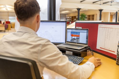 Man in White Shirt Working in Office