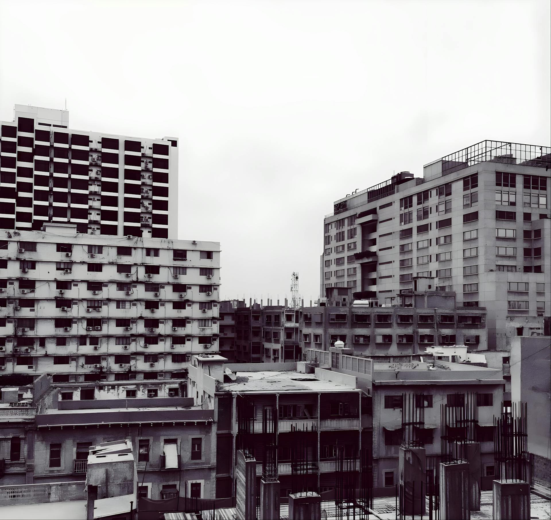 High-rise residential buildings dominate the Karachi skyline in a modern urban setting.