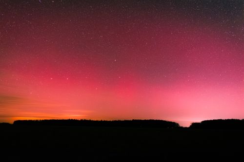 Free Breathtaking view of aurora borealis illuminating a star-filled night sky with vibrant colors. Stock Photo