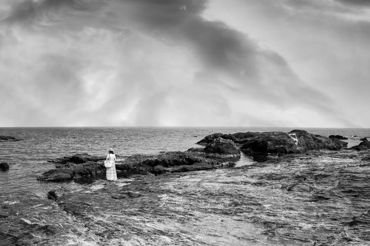 Tourist On The Rocky Seashore