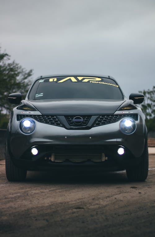 Front of a Parked Nissan Juke with its Lights On