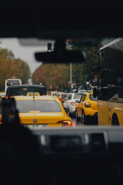 Free A busy city street with yellow taxis and other vehicles stuck in traffic jam. Stock Photo