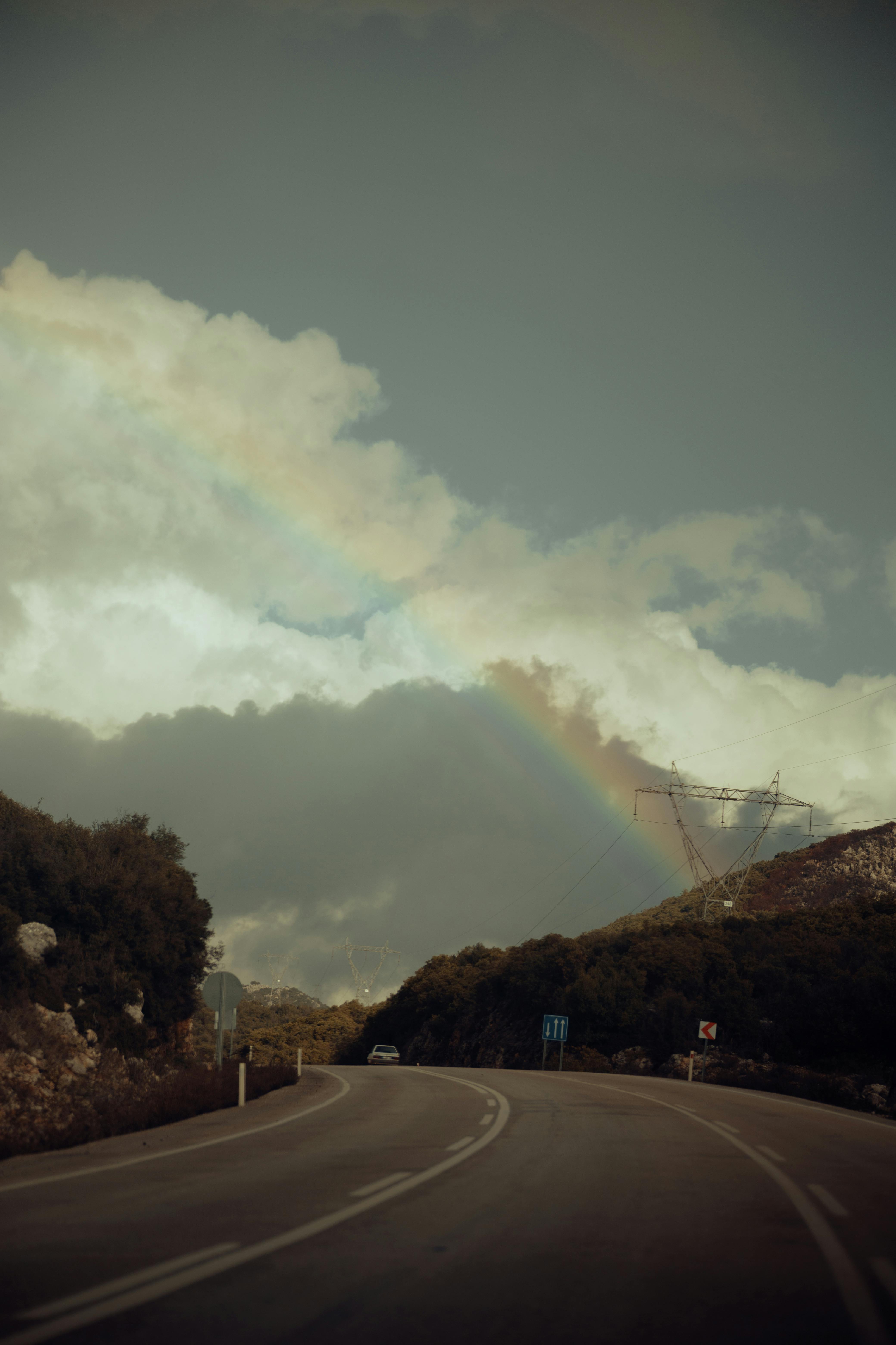 Rainbow over Bending Road · Free Stock Photo