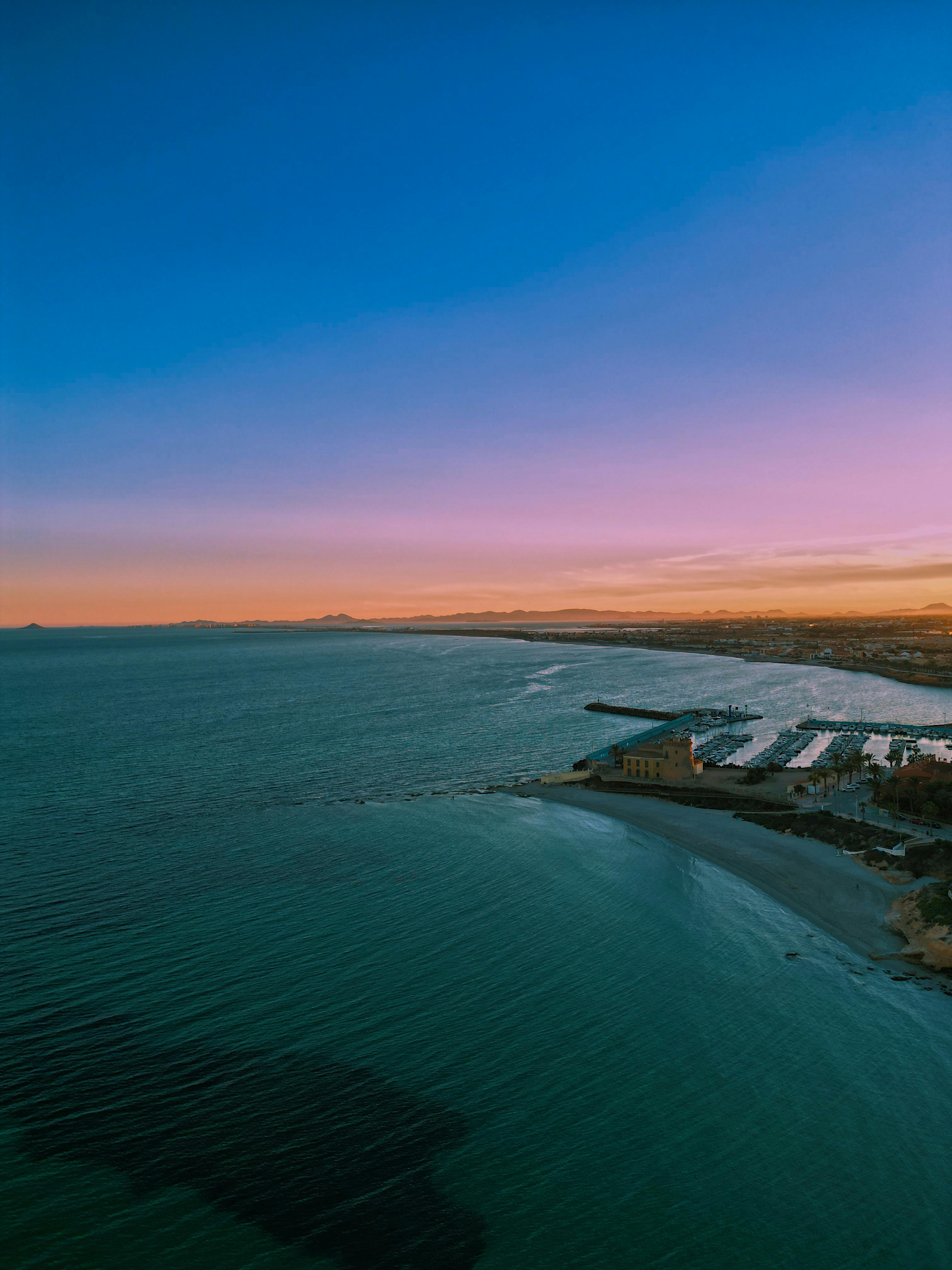 Stunning aerial view capturing the serene coastline at sunrise in Pilar de la Horadada, Spain.