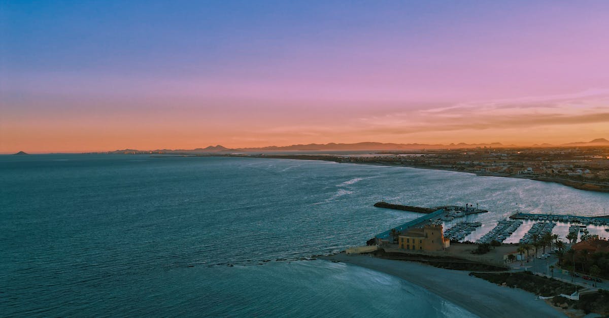 Stunning aerial view capturing the serene coastline at sunrise in Pilar de la Horadada, Spain.