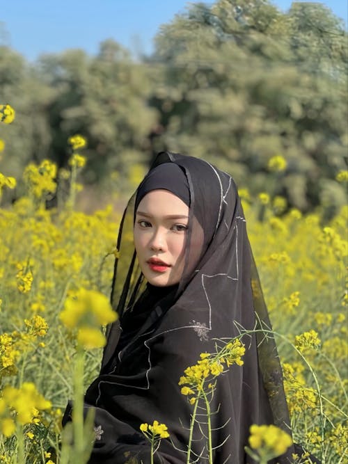 Portrait of Woman in Hijab among Flowers