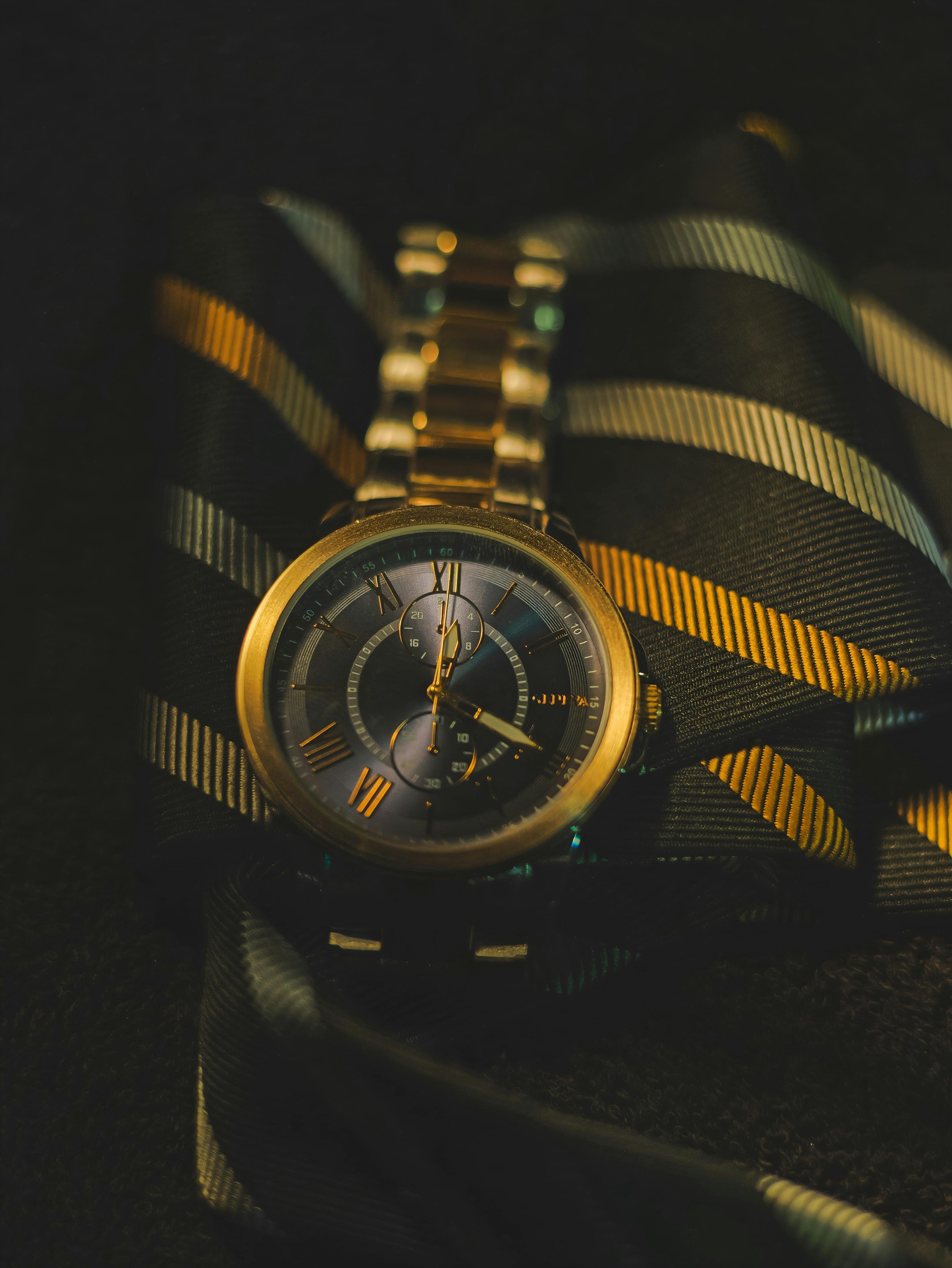 golden wristwatch on black background