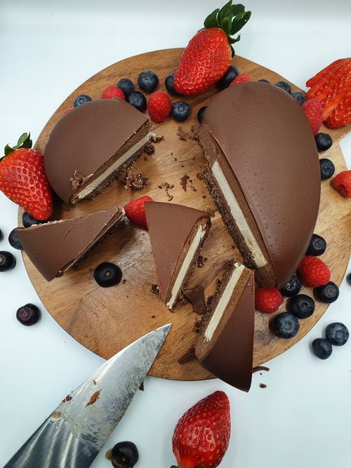 Free Sliced chocolate dessert with strawberries and blueberries on a wooden tray. Stock Photo
