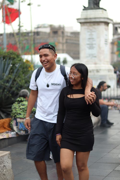 A man and woman walking together in a city