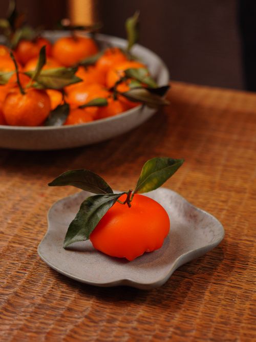 Free Vibrant tangerines with leaves on a rustic table create a natural and organic feel. Stock Photo