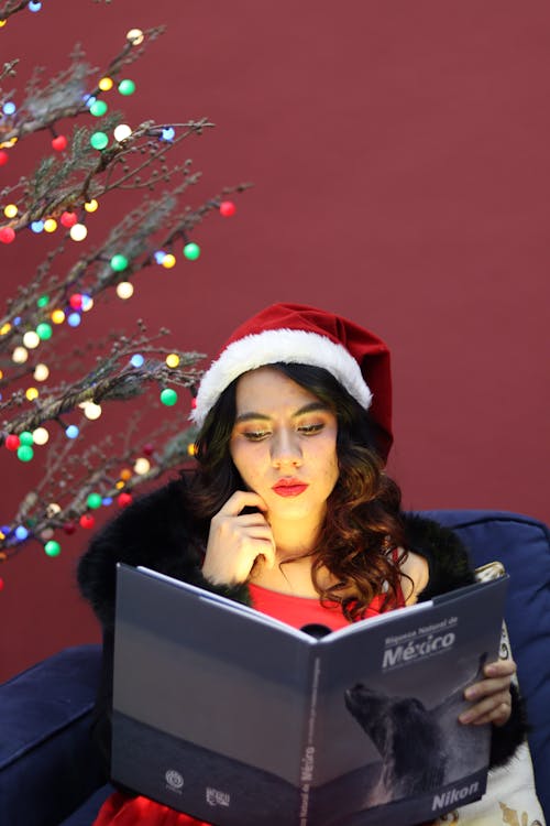 Woman in Santa Hat Reading Book