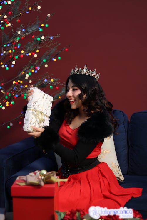 Smiling Woman in Crown and with Christmas Gift