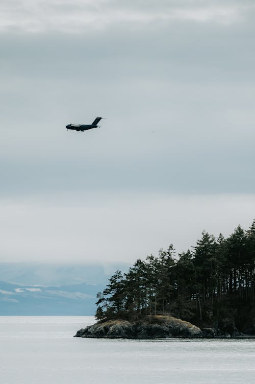 Cargo Plane Flying over a Sea Island