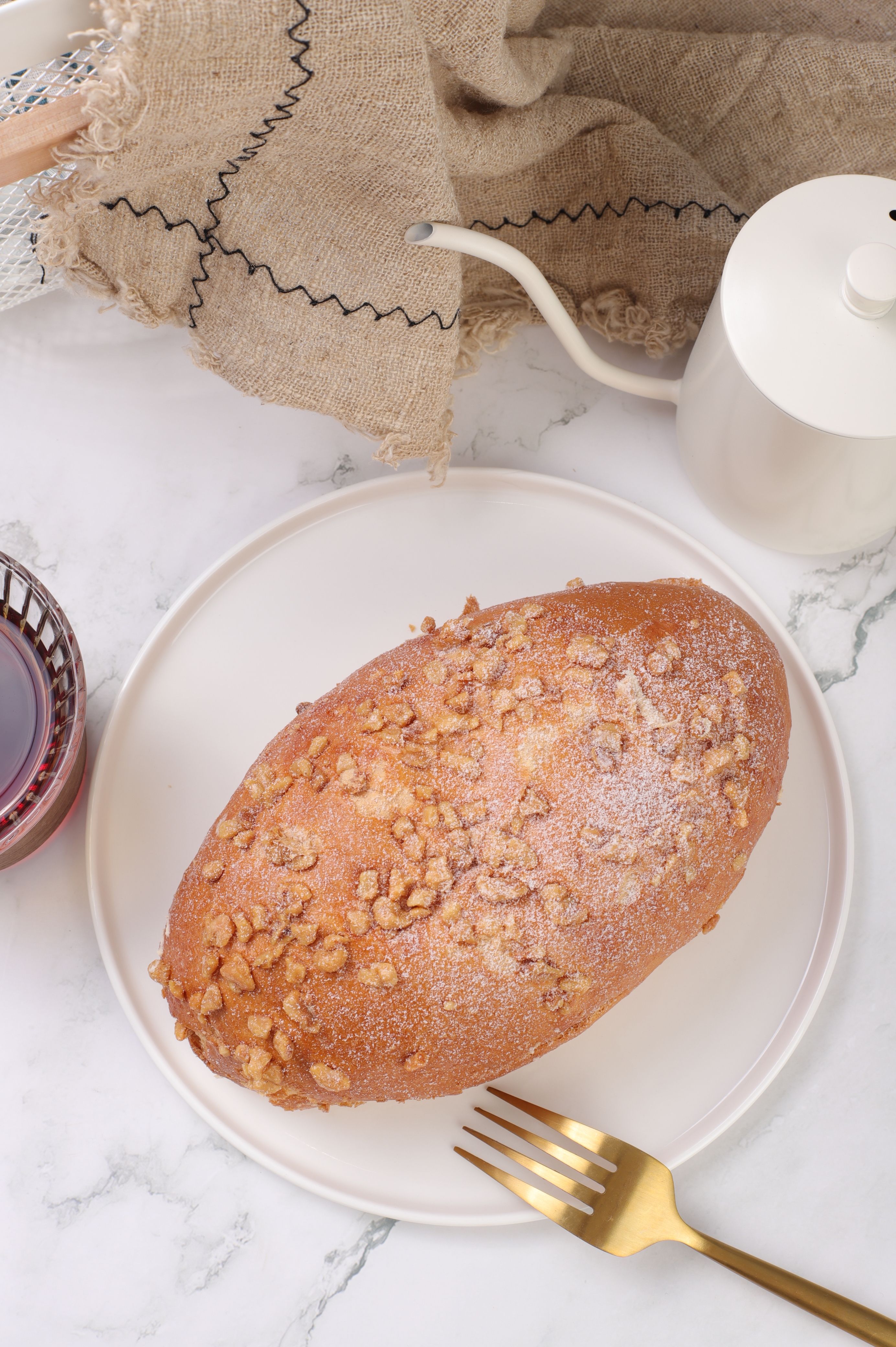 Top view of a fresh walnut bread loaf on a plate, perfect for breakfast.
